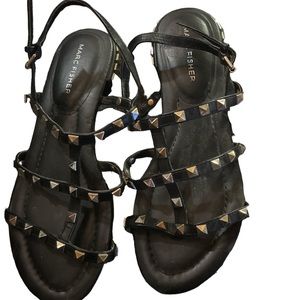 This is a pair of marc fisher sandals with studs
